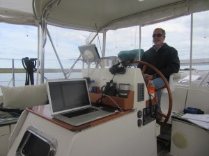 Captain D at the helm with lots of gadgets nearby.