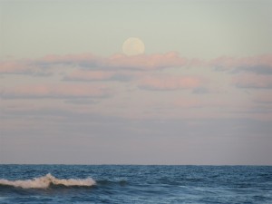 Full moon rising over the ocean at dusk