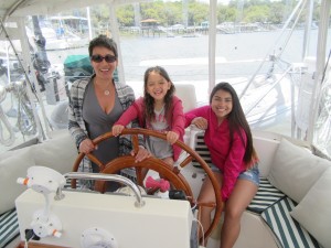 Jan, Ella, and Zoe in the cockpit of Belle Bateau.